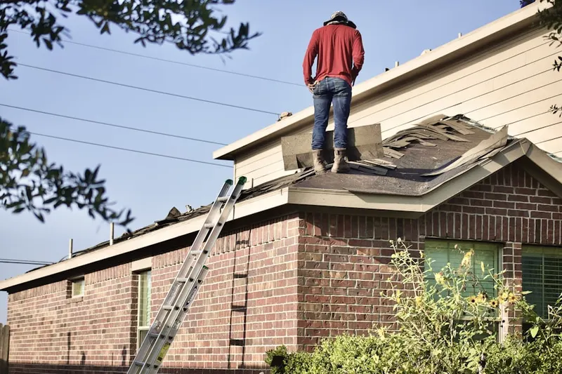 Professional roofer working on a residential roof in Putnamville